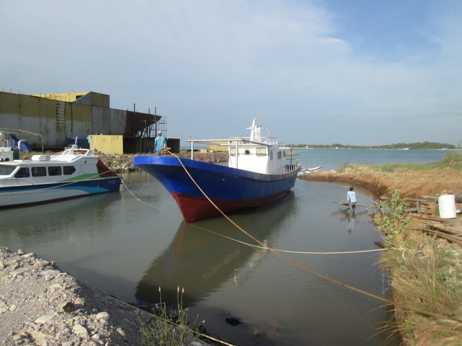 Fishing boat in the canal beside an AGM crewboat